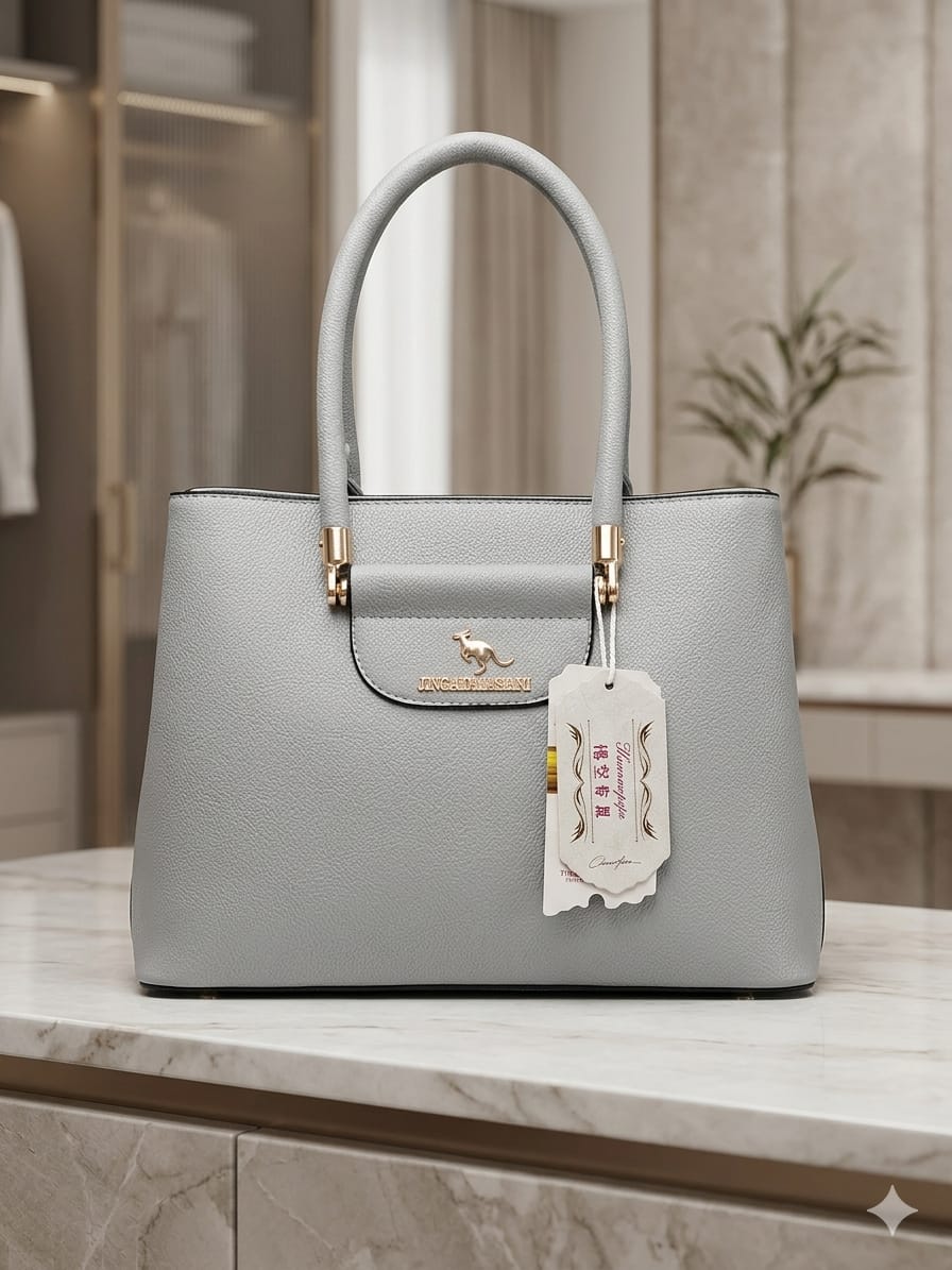 Gray handbag with a visible brand tag on a marble surface