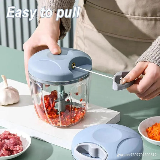 Person using a hand-chopper with ingredients on a table