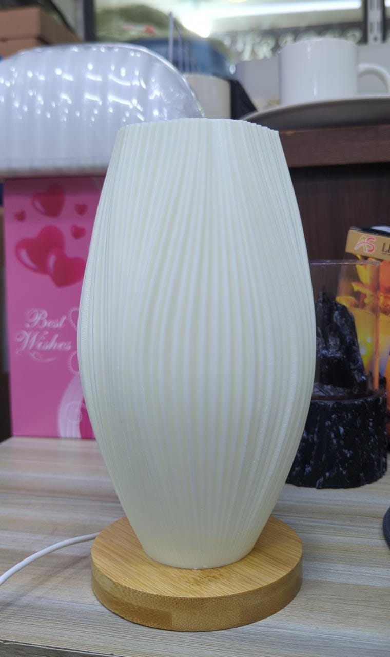 White textured table lamp with wooden base on a surface