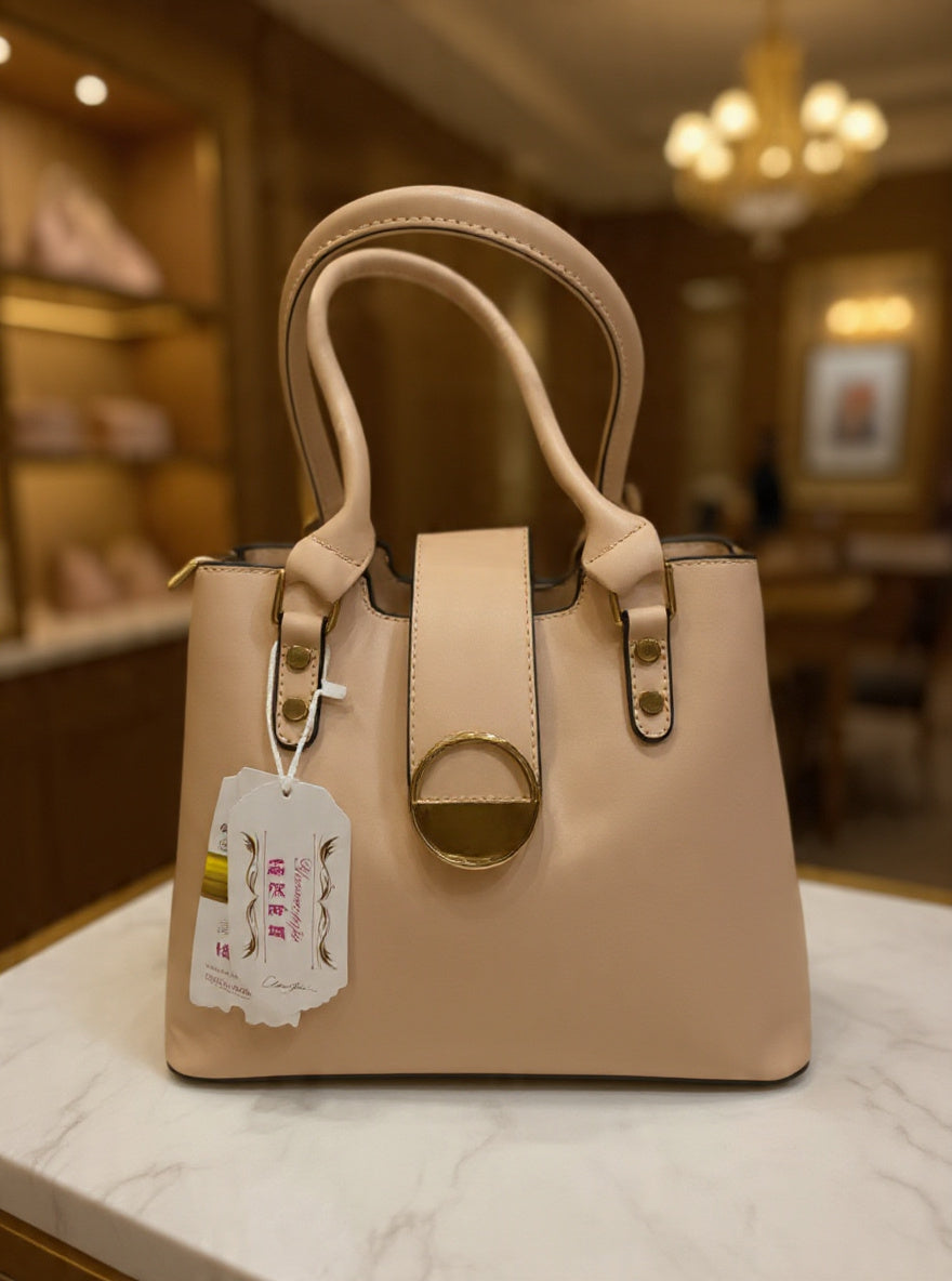 Beige handbag with a tag on a marble surface in an indoor setting