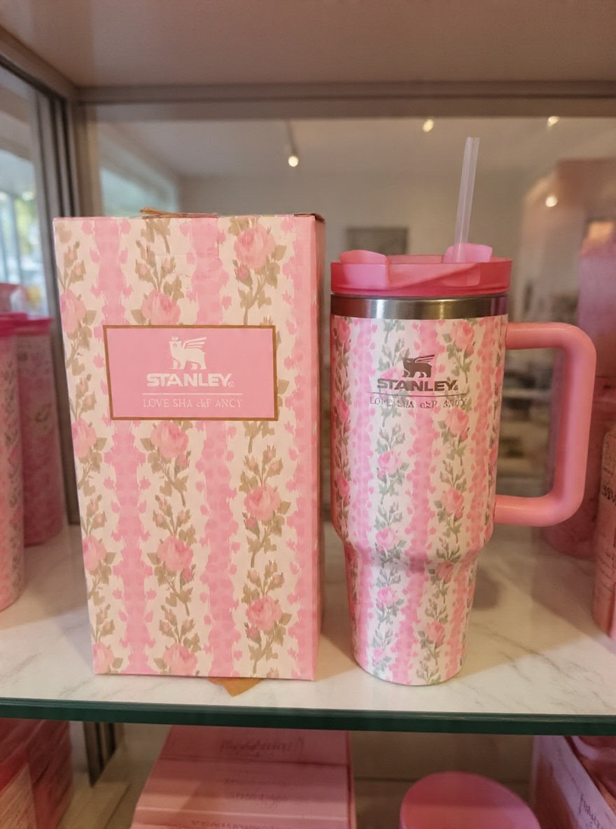 Pink floral Stanley mug and packaging on a shelf